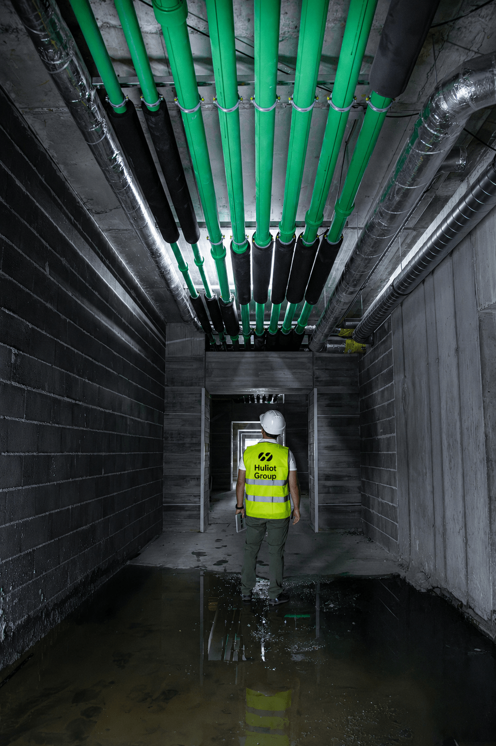 Huliot Group engineer inspecting PP-R CT green piping system installed in a data center cooling infrastructure corridor